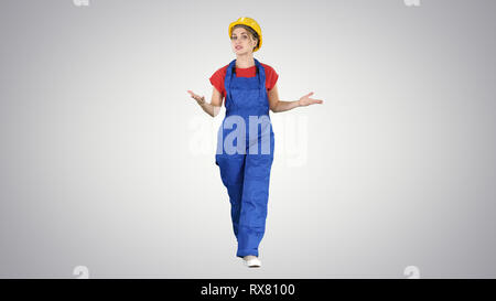 Full length shot. Cheerful female construction worker talking to camera on gradient background. Professional shot in 4K resolution. 006. You can use i Stock Photo
