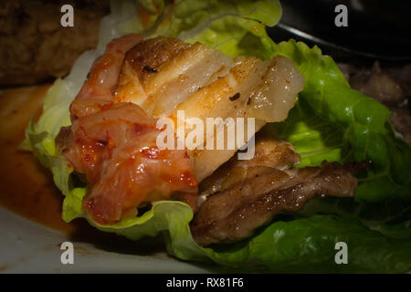 Grilled pork on a raw lettuce Stock Photo