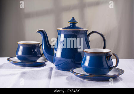 Old-fashioned teapot and matching cups and saucers Stock Photo