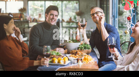 Dinner with friends. Group of happy young people enjoying dinner together. Stock Photo