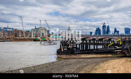 London, UK, Aug 2018, construction barge on the South Bank of the River Thames at low tide and the construction work on the North Bank, England Stock Photo