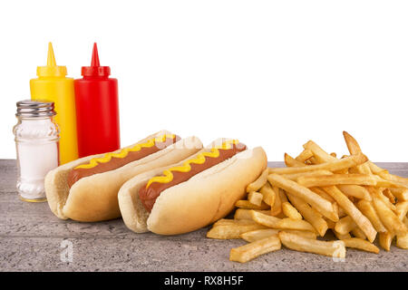 Duo of hot dogs and french fries on table. Fast food restaurant concept. Copy space for your text. Stock Photo