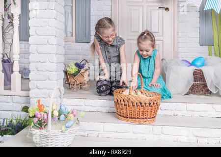 children look at chickens in a wicker basket, pointing at them with a finger Stock Photo