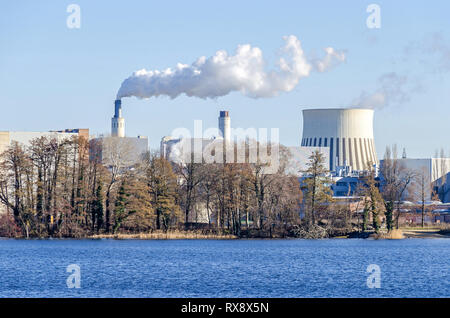Berlin, Germany - February 22, 2019: Cooling tower and chimney stacks of the Reuter West environmentally compatible combined heat and power plant Stock Photo