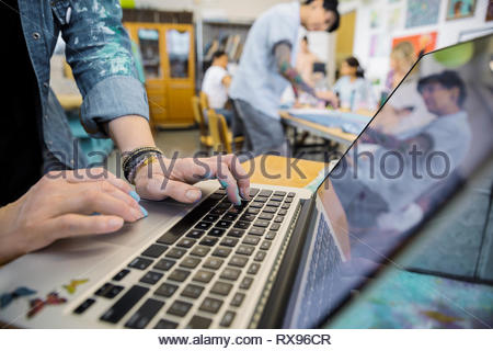 Close up female artist using laptop