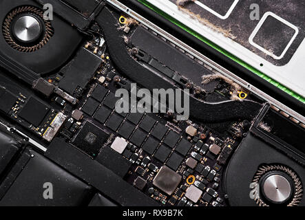 Full frame of disassembled computer electronic device, closeup inside of laptop with lot of dust, need repair clean service  conceptual image Stock Photo