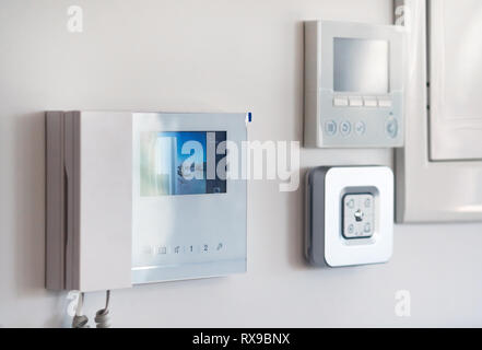 Concept of smart modern luxury wealthy home. On white wall home security alarm and video intercom with street view talkback or doorphone voice communi Stock Photo