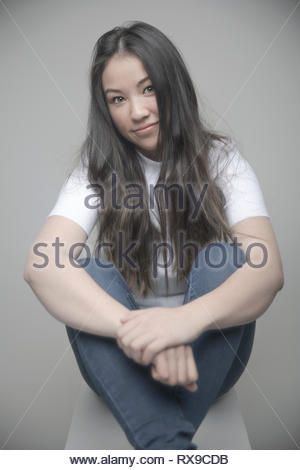 Portrait confident beautiful teenage girl with long black hair