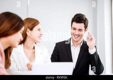 businessman talking and smiling.Young team of coworkers making great business discussion in modern office.Teamwork people concept. Stock Photo