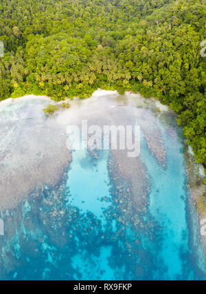 Aerial view of reef and island in Papua New Guinea. The remote, tropical islands in this region are home to extraordinary marine biodiversity. Stock Photo