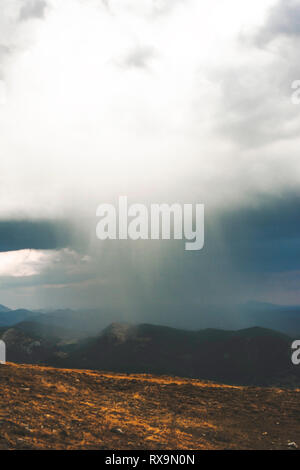 Scenic view of mountains against storm clouds Stock Photo