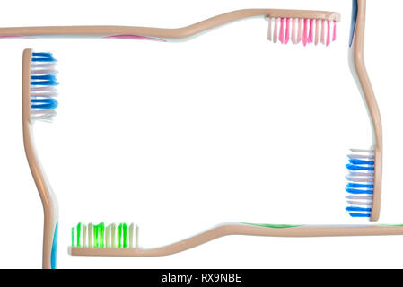 Horizontal shot of four toothbrushes forming a frame on a white background.  Copy space. Stock Photo