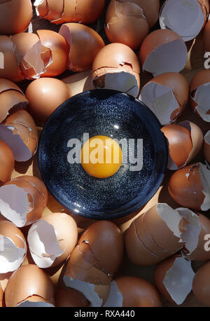 Overhead view of egg yolk in plate on eggshells Stock Photo