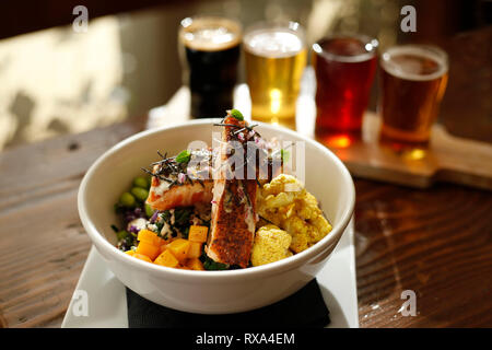 High angle view of food in bowl with beer glasses on wooden table Stock Photo