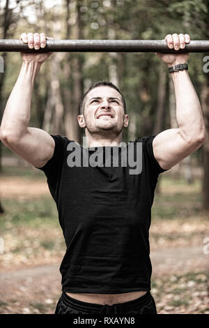 Man doing pull ups Stock Photo