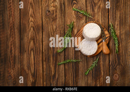 Brie cheese or camembert on woden board with knife for soft cheese Stock Photo