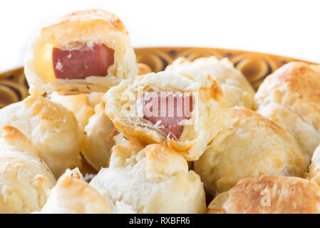 Appetizers. Puff pastry wrapped around a sausage (wurstel) and cheese Stock Photo