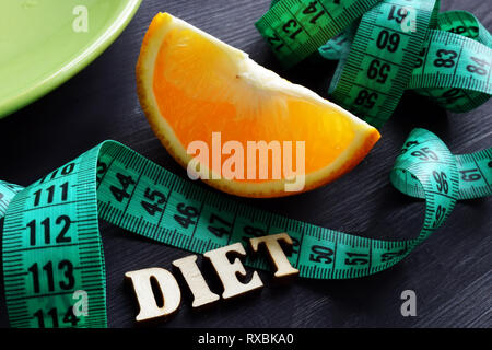 Weight loss concept. Plate and word diet on a desk. Stock Photo