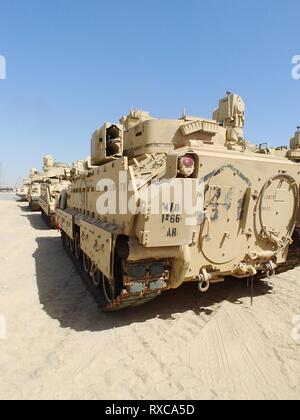 420th Transportation Battalion coordinates contracted assets to move 3d Armored Brigade Combat Team, 4th Infantry Division equipment from port to Camp Buehring, Kuwait, Feb. 28, 2019.  (U.S. Army photo by Capt. Robert Bowman) Stock Photo