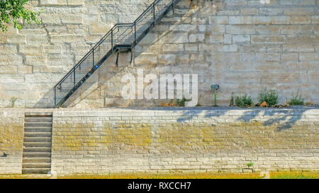 A ladder going up to a building in Paris. A long thin ladder located on the side of the building Stock Photo