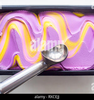 Multicolored pink, blue and purple gum flavor ice cream in metallic form with a special ice cream spoon Stock Photo