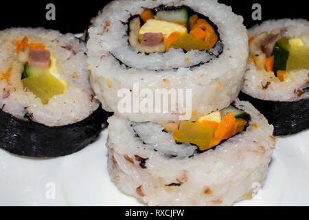 Stacked sushi roll placed on a white plate, Asian cuisine, Koren Dish, Japanese dish Stock Photo