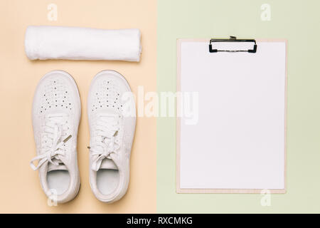 Athlete's set with female clothing, dumbbells and bottle of water on pastel color background Stock Photo