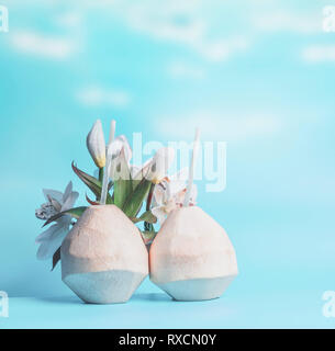 Two coconut cocktails in fresh coconuts at blue sky background. Summer tropical drinks Stock Photo