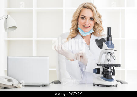 Young scientist with microscope in a laboratory doing some research Stock Photo