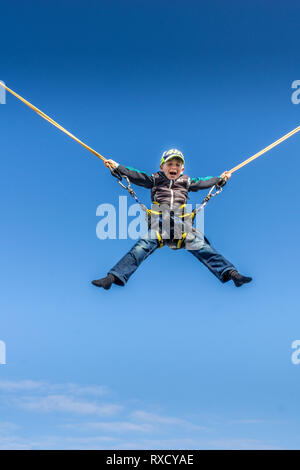 Little children jumping on the trampoline - bungee Stock Photo