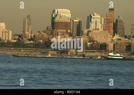 Tugboat on Hudson River, with view of buildings in the Lower Manhattan, New York, USA Stock Photo