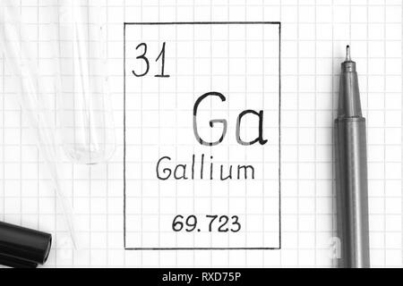 The Periodic table of elements. Handwriting chemical element Gallium Ga with black pen, test tube and pipette. Close-up. Stock Photo