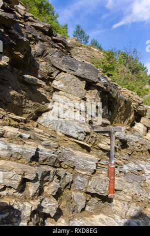 Geological hammer on the rocks Stock Photo