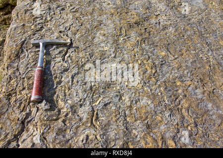 Geological hammer on the rocks Stock Photo