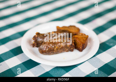 Pork wine sausage and belly in local restaurant in Larnaca. Traditional cypriot meze food on Cyprus island. Stock Photo