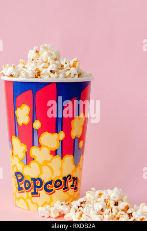 Popcorn on a pastel pink background and a place for text. Flat lay. Copyspace. Cinema Concept. Background. Stock Photo