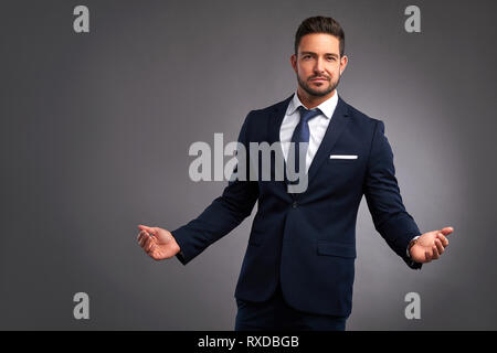 An elegant handsome young man looking uncomprehendingly in to the camera Stock Photo