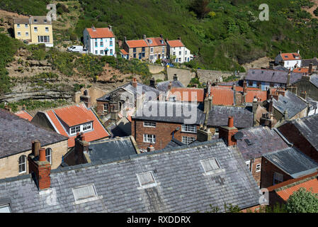 The picturesque coastal village of Staithes, North Yorkshire, England. Looking over the rooftops to Cowbar Nab beside Staithes Beck.