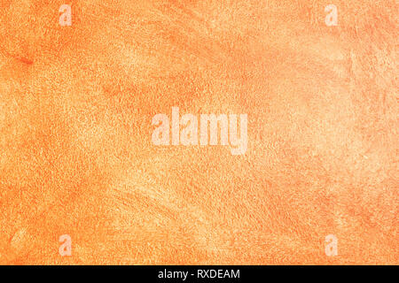 textured background - orange painted wall glistening in the sunlight in Bergamo town, Italy Stock Photo