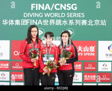 Beijing, China. 9th Mar, 2019. Gold medalist Zhang Jiaqi (C) of China and silver medalist Ren qian (L) of China and bronze medalist Meaghan Benfeito of Canada react during the awarding ceremony for women's 10m platform at the FINA Diving World Series 2019 at the National Aquatics Center in Beijing, capital of China, March 9, 2019. Credit: Jia Haocheng/Xinhua/Alamy Live News Stock Photo