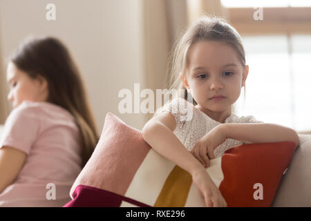 Upset kid daughter feeling sad after fight with mother Stock Photo