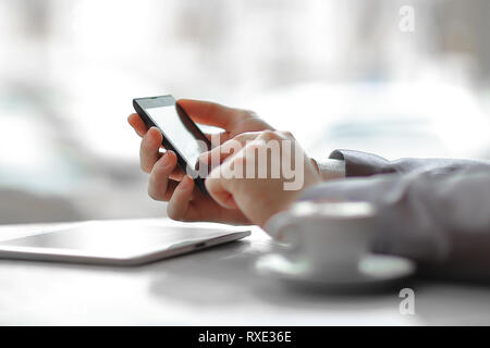 close up.businessman presses his finger on the screen of the smartphone Stock Photo
