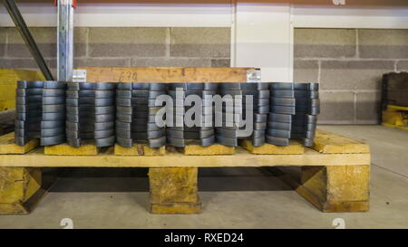 Set of many big wrenches on the wooden block. These are found on one side of the room inside the factory Stock Photo