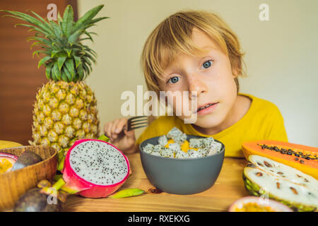Boy eats fruit. Healthy food for children. Child eating healthy snack. Vegetarian nutrition for kids. Vitamins for children. Stock Photo
