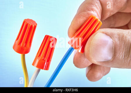 Twist-on wire connectors are a type of electrical connector used to fasten two or more low-voltage electrical conductors. Stock Photo