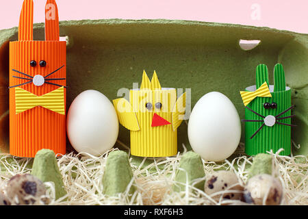 Easter spring decorative composition with homemade easter paper craft funny rabbit, chickens and quail eggs .Holiday celebration decorations. Stock Photo