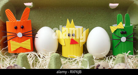 Easter spring decorative composition with homemade easter paper craft funny rabbit, chickens and quail eggs .Holiday celebration decorations. Stock Photo