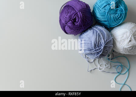 Colored yarn wools for hand knitting  isolated on white table background. Stock Photo