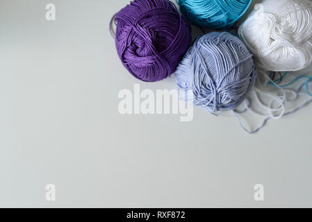 Colorful cotton yarn balls for handmade on white table background with copy space. Stock Photo