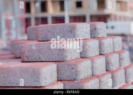 New paving slab on pallets, building materials for the reconstruction of the pavement. Selective focus, close-up. Stock Photo